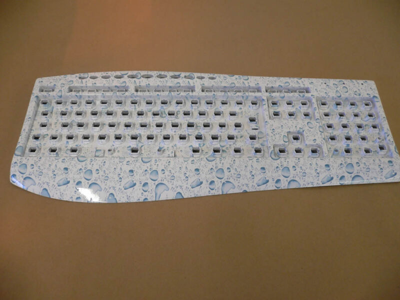 PC Keyboard in water drops over white base