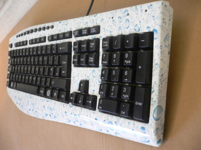 PC Keyboard water drops over white base