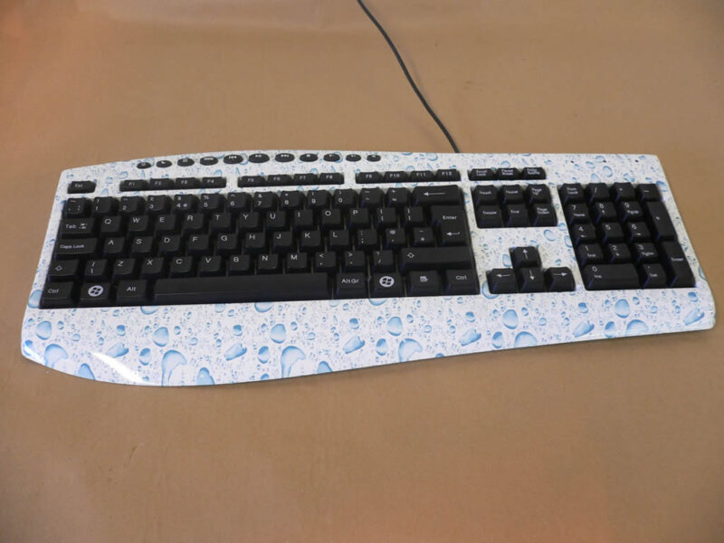 PC Keyboard water drops over white base