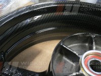 Close up of carbon dipping on Honda CBR 600 motorcycle rear wheel