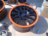 Carbon dipped wheel with bright orange painted rim