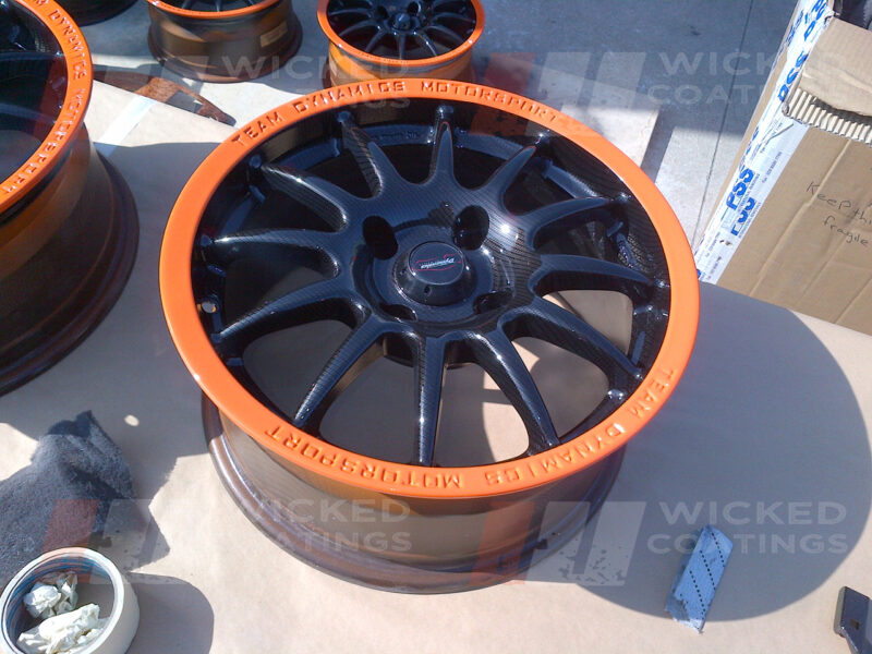 Carbon dipped wheel with bright orange painted rim