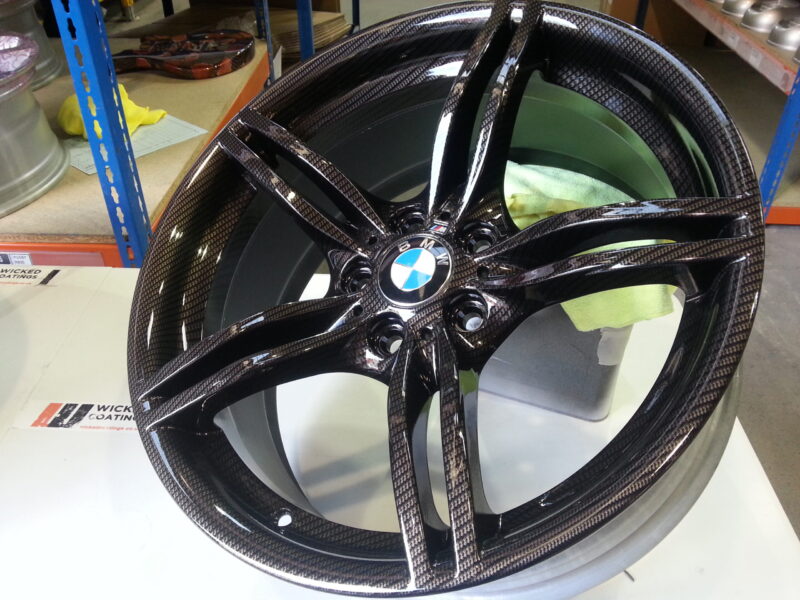 BMW M-Power alloy wheels coated in carbon fibre painted black