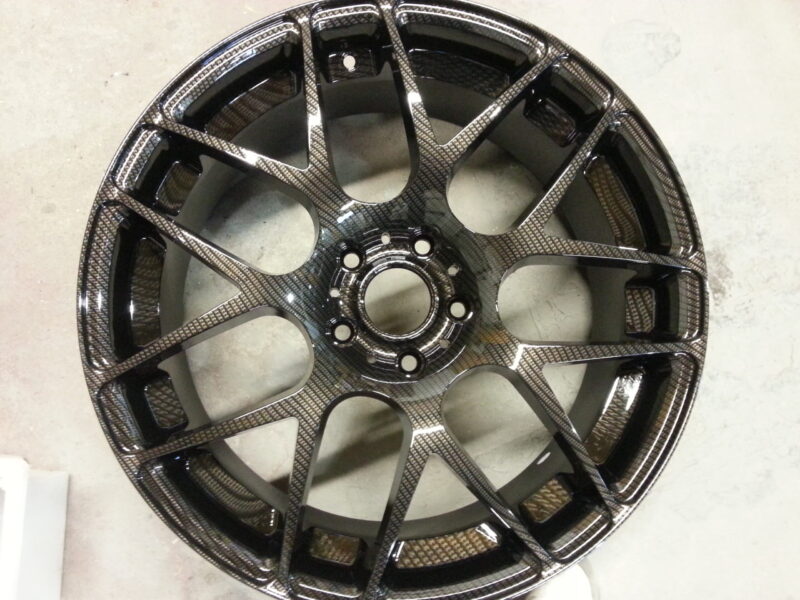 Car alloy wheels coated in carbon fibre