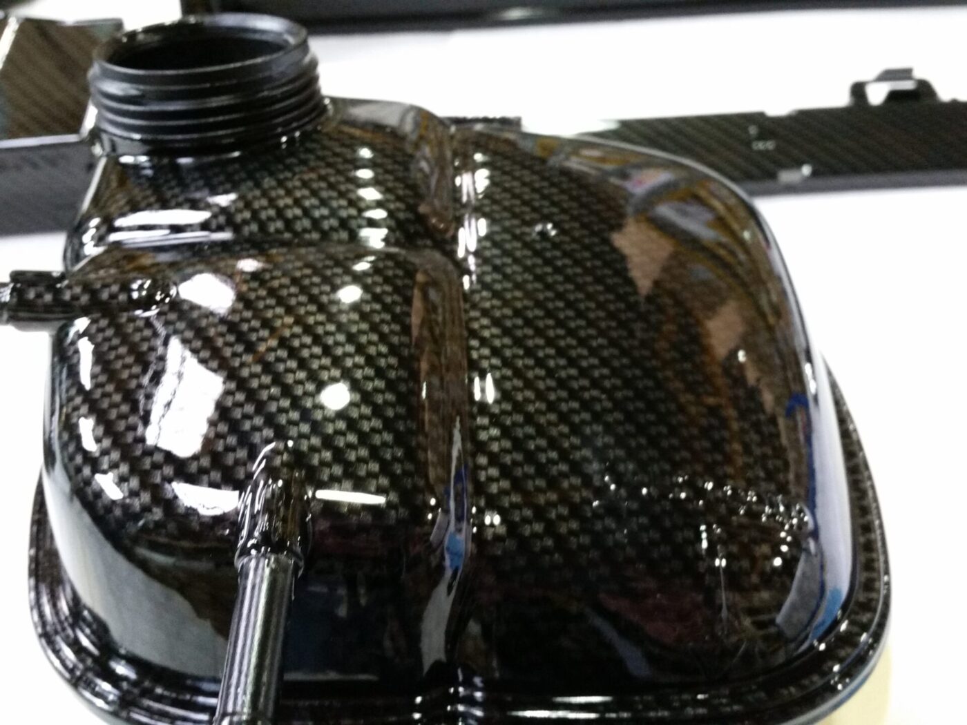 Car engine elements coated in carbon fibre hydrographic film painted black