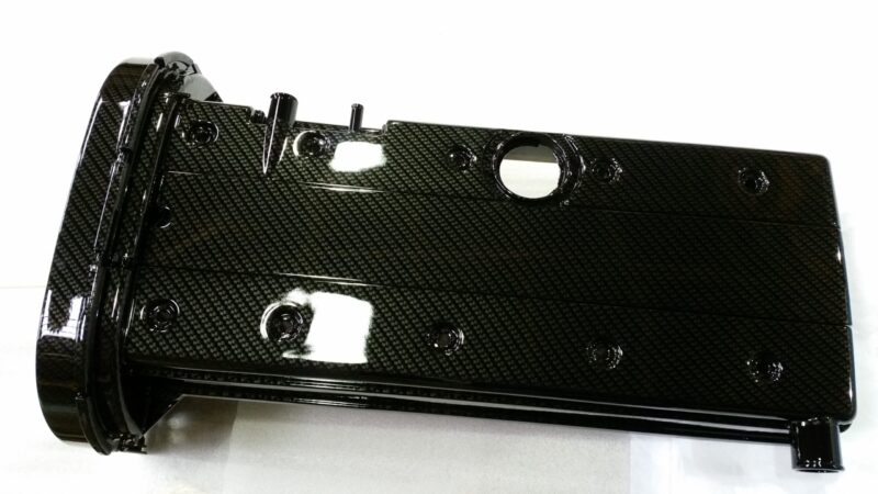 Car engine elements coated in carbon fibre hydrographic film painted black