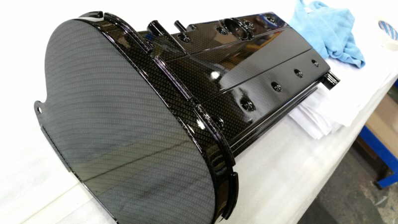 Car engine elements coated in carbon fibre hydrographic film painted black
