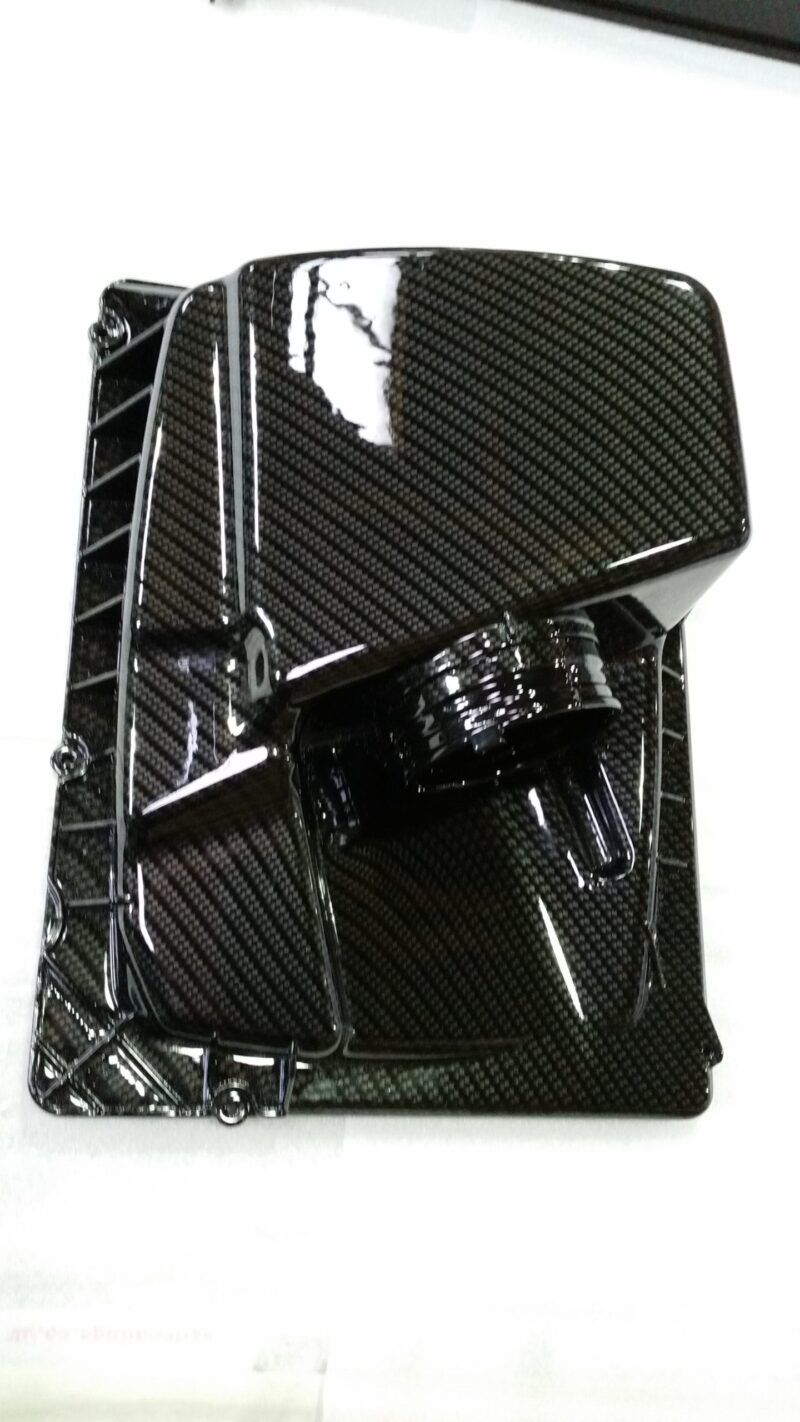 Car engine elements coated in carbon fibre hydrographic film painted black