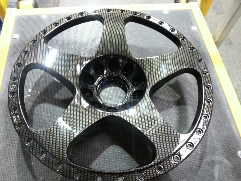 Car alloy wheels coated in carbon fibre hydrographic film painted black
