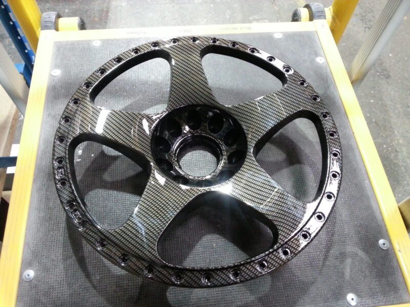 Car alloy wheels coated in carbon fibre hydrographic film painted black