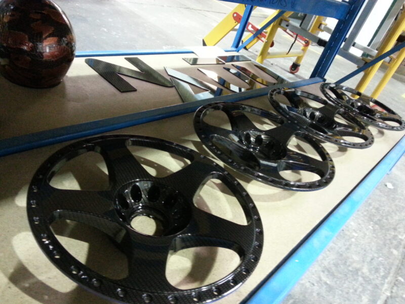 Car alloy wheels coated in carbon fibre hydrographic film painted black