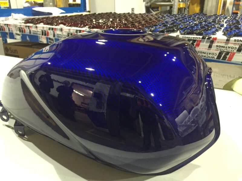 Motorbike tank coated in carbon fibre painted blue
