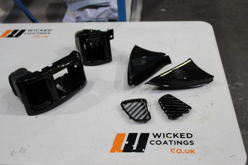 Car interior parts coated in carbon fibre