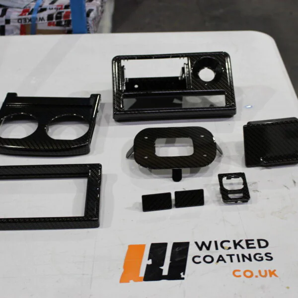 Car dashboard elements coated in carbon fibre