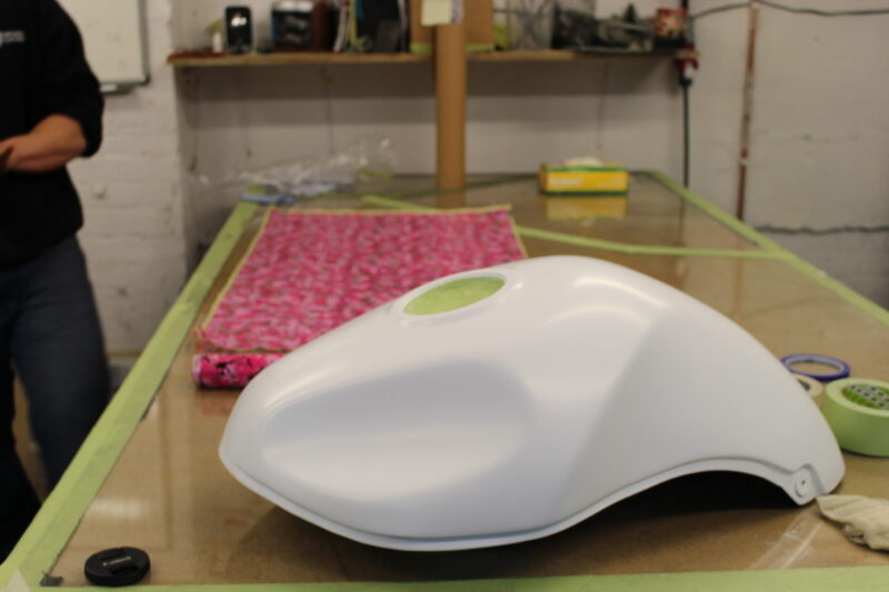 Motorbike tank painted in white, coated in fancy como hydrographic film.