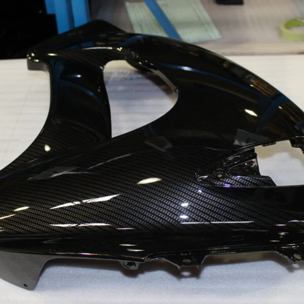 Various motorbike parts coated in carbon fibre