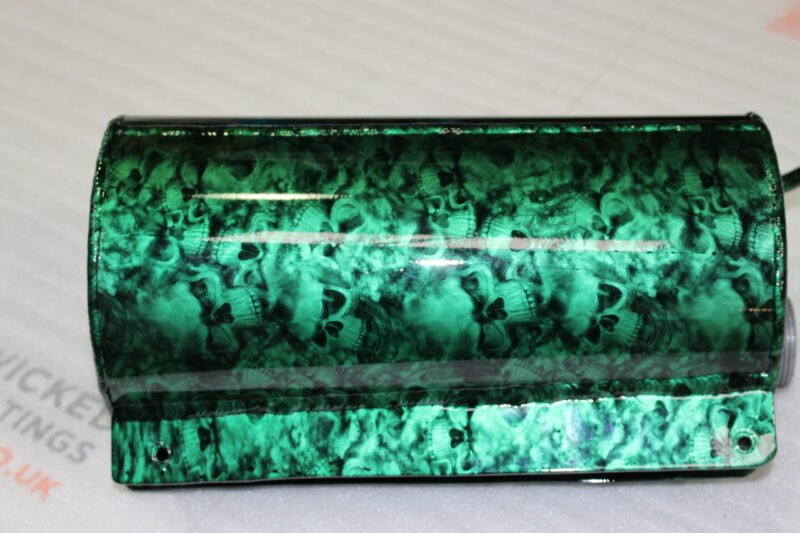 Exhaust coated in skull pattern painted green