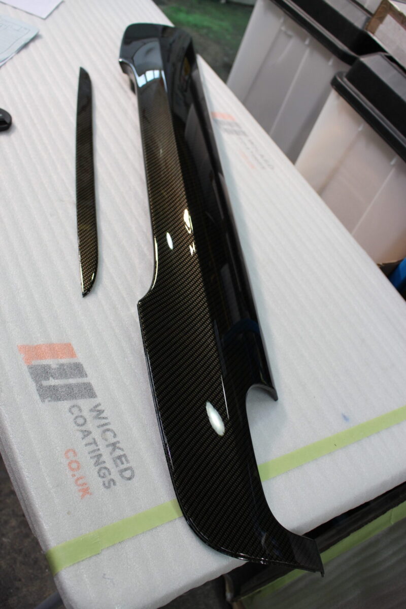 Car exterior element coated in carbon fibre
