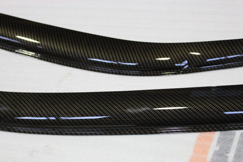 Car exterior element coated in carbon fibre