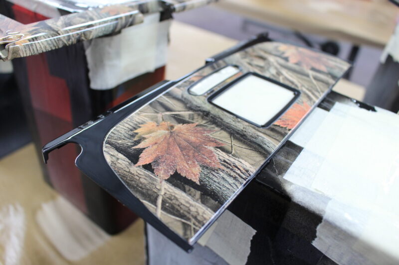 Parts of dashboard coated in camouflage hydrographic film