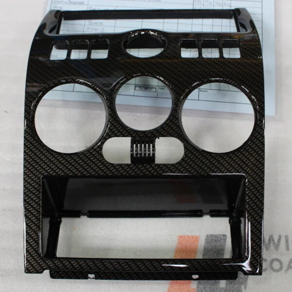 Parts of dashboard coated in carbon fibre