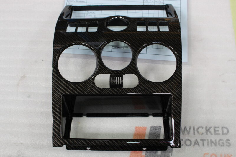 Parts of dashboard coated in carbon fibre