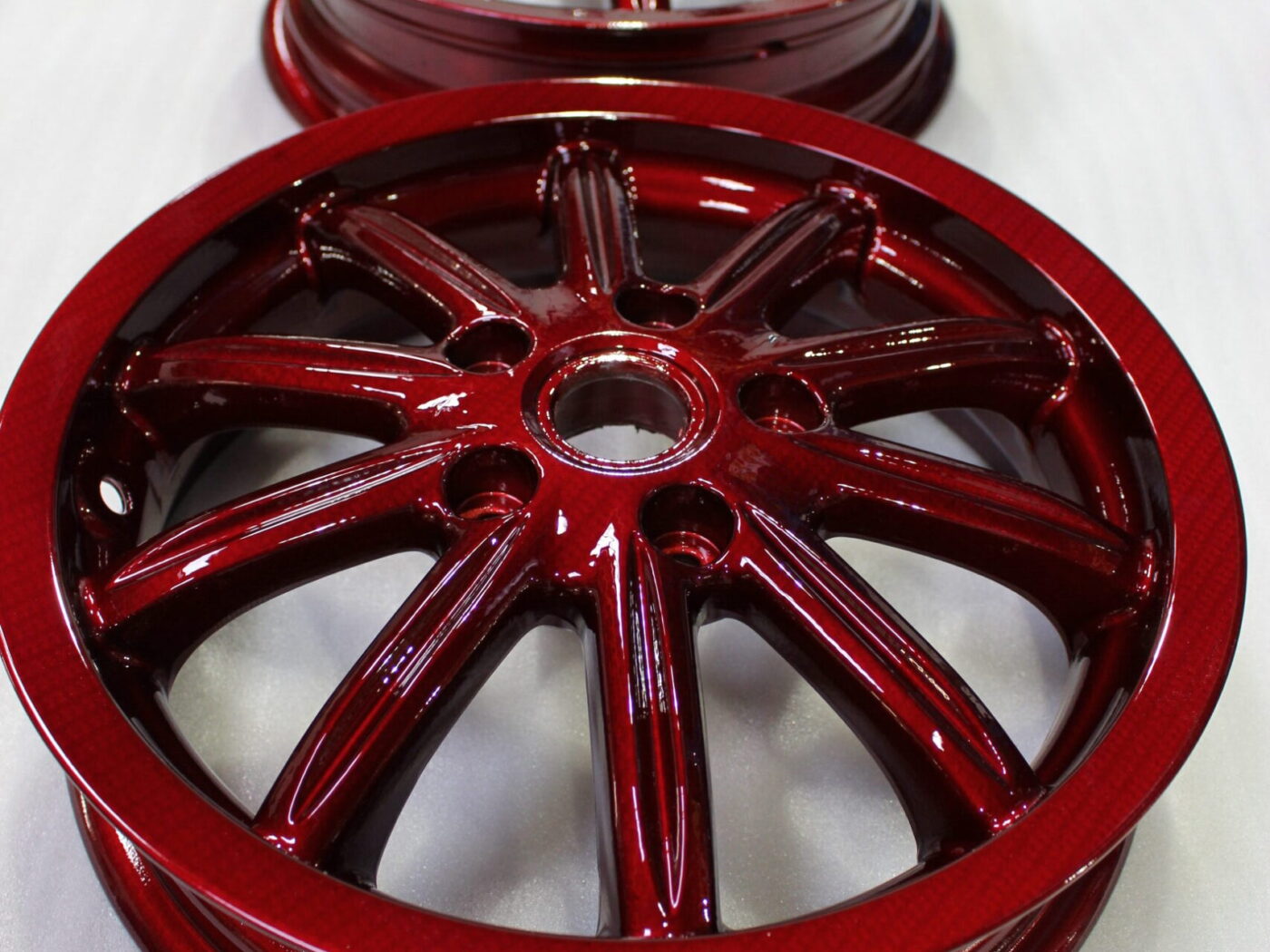 Car alloy wheels coated in carbon fibre painted red