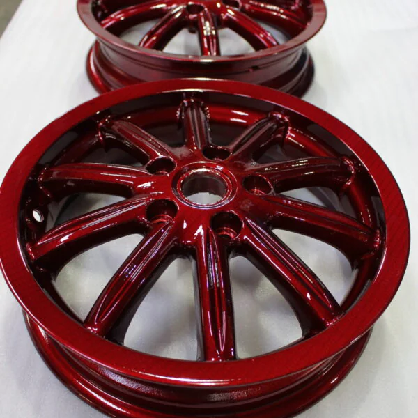 Car alloy wheels coated in carbon fibre painted red