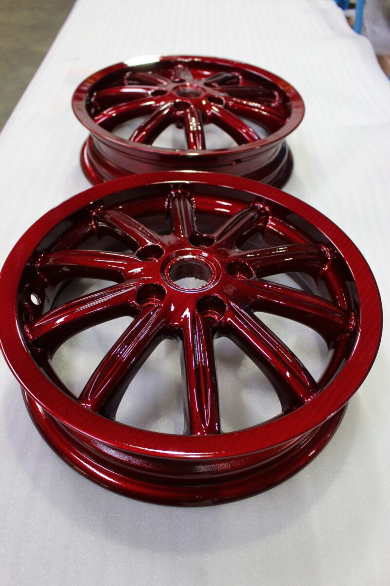 Car alloy wheels coated in carbon fibre painted red
