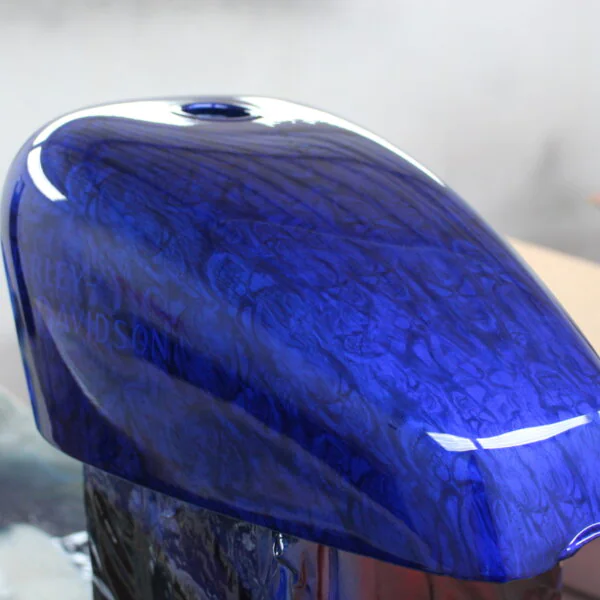 Motorbike tank coated in skull pattern painted blue