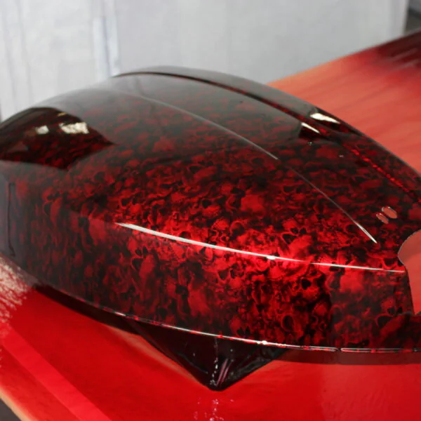 Motorbike parts coated in skulls painted red