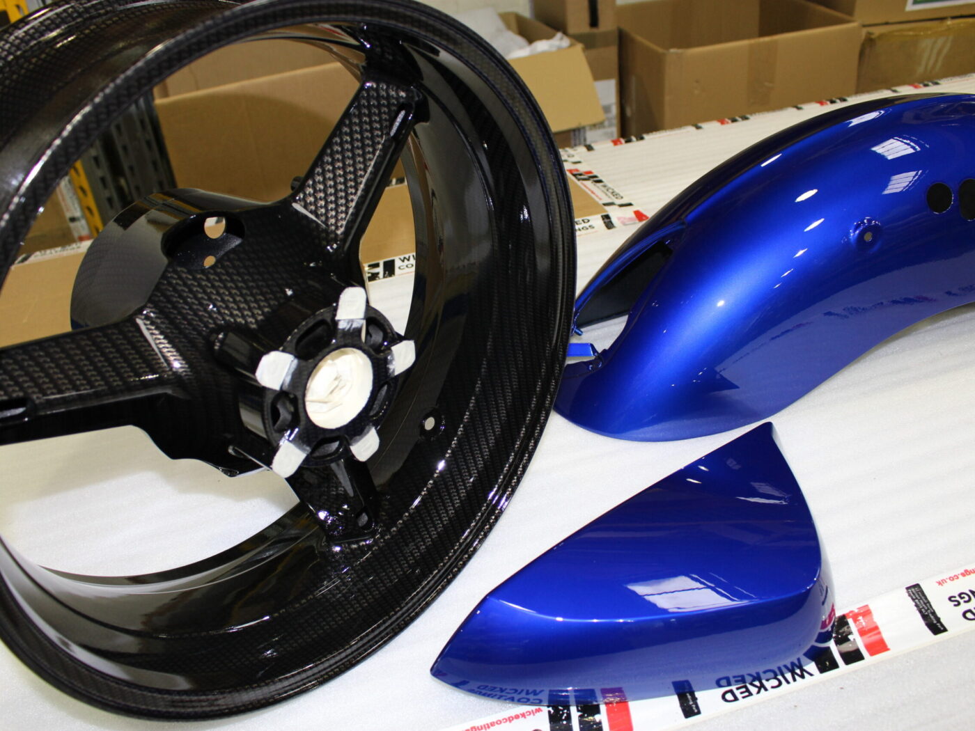 Motorbike parts coated in carbon fibre painted blue