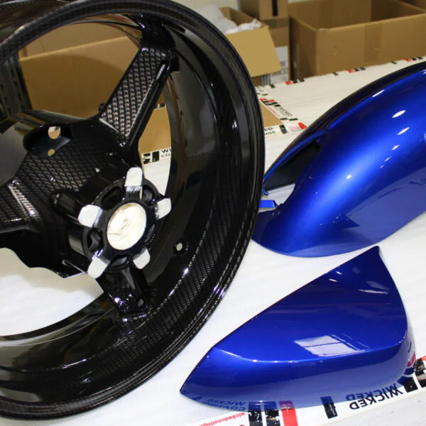 Motorbike parts coated in carbon fibre painted blue