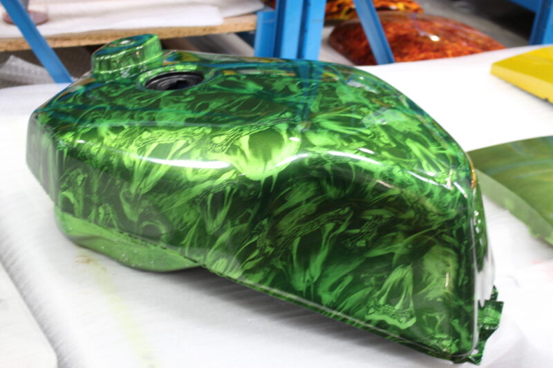 Motorbike tank coated in snakes painted green