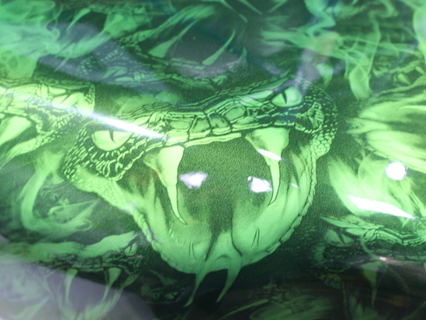 Motorbike tank coated in snakes painted green