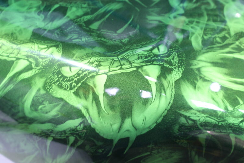Motorbike tank coated in snakes painted green