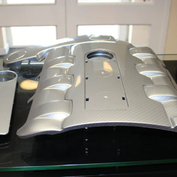 Car engine element coated in carbon fibre painted silver