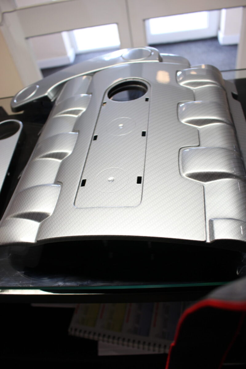 Car engine element coated in carbon fibre painted silver
