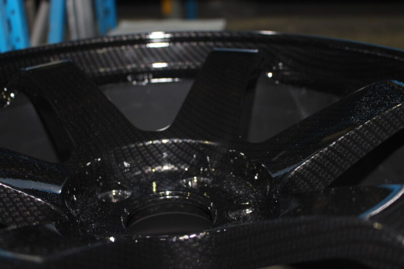 Car alloy wheels coated in carbon fibre