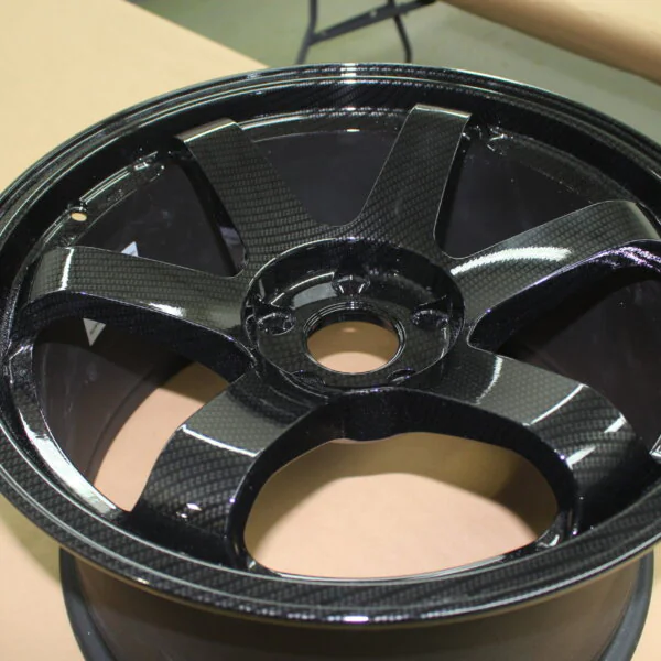 Car alloy wheels coated in carbon fibre