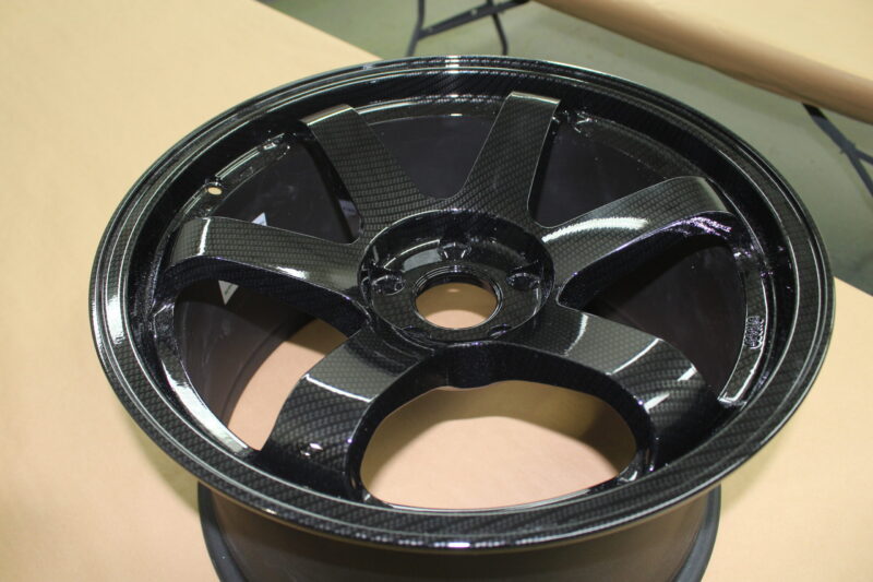Car alloy wheels coated in carbon fibre