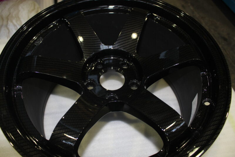 Car alloy wheels coated in carbon fibre