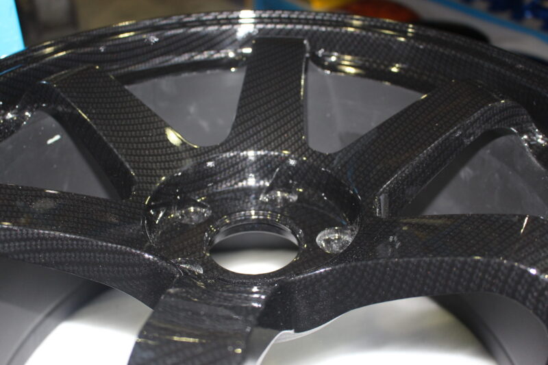 Car alloy wheels coated in carbon fibre