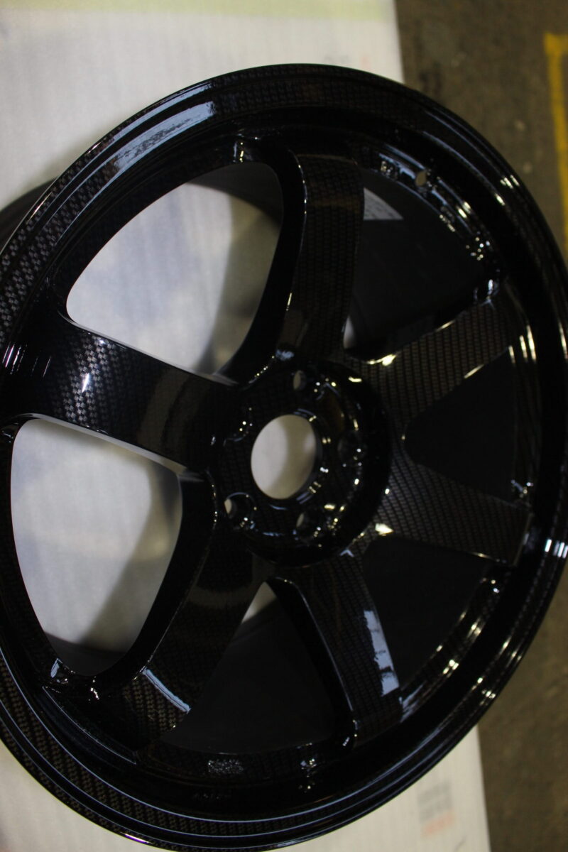 Car alloy wheels coated in carbon fibre