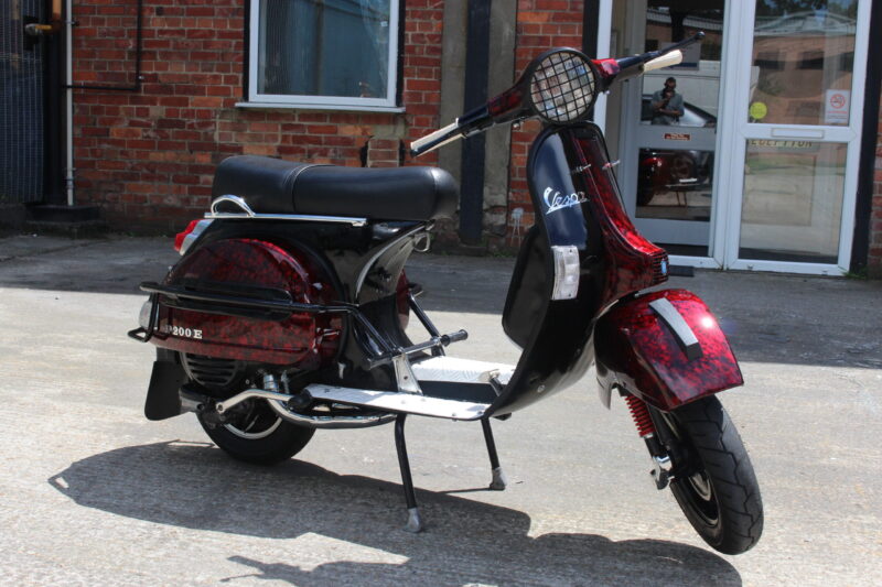 Vespa P200E skuter coated in dark skulls