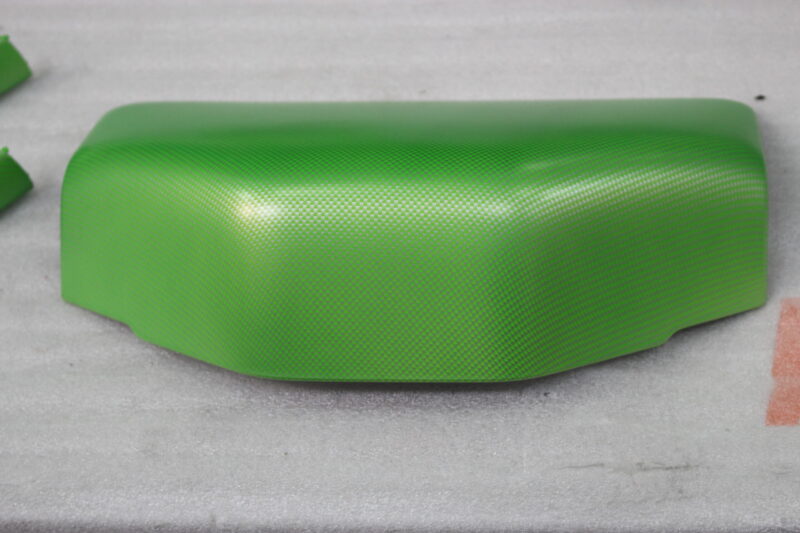 Car interior elements coated in carbon fibre painted green