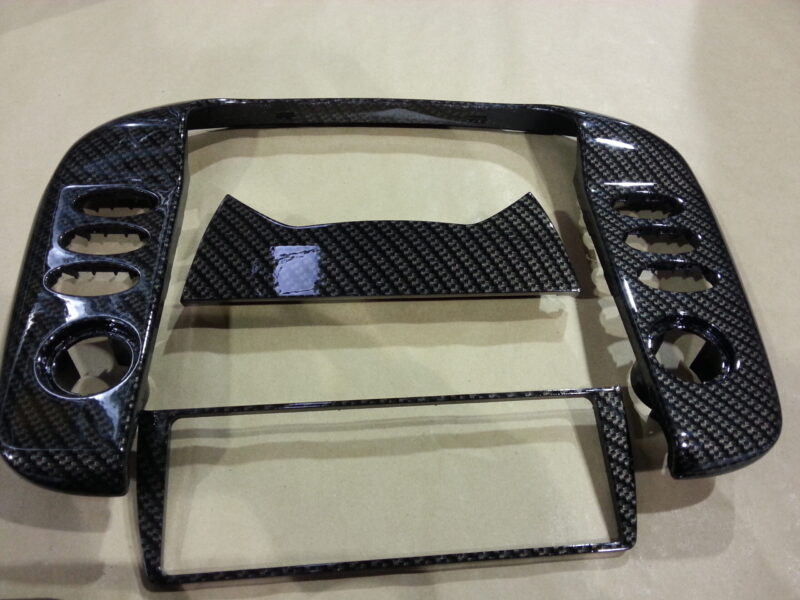 Car interior part coated in carbon fibre hydrographic film painted black