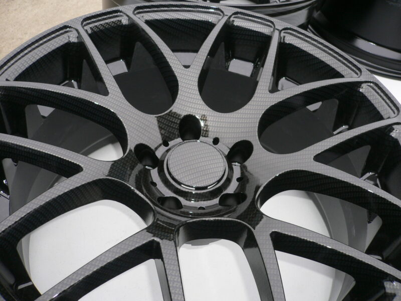 Car alloy wheels coated in carbon fibre