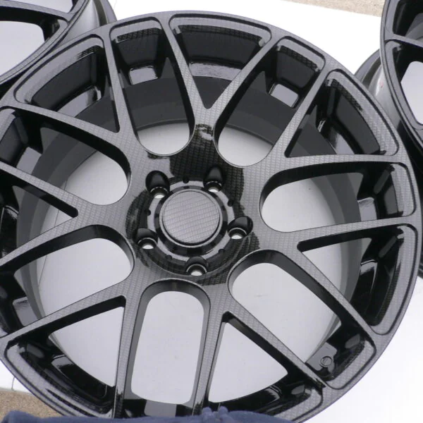 Car alloy wheels coated in carbon fibre