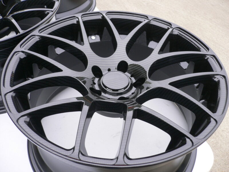 Car alloy wheels coated in carbon fibre
